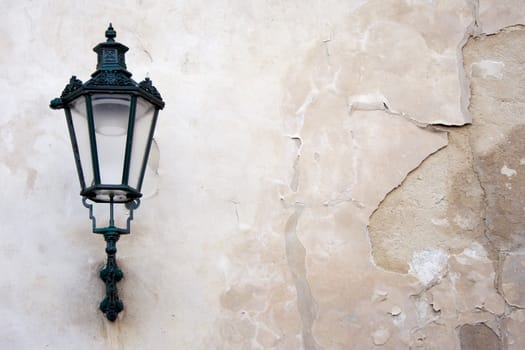 Lantern on a weathered wall.