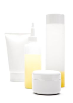 Various blank tubes, bottles and pots isolated on a white background.