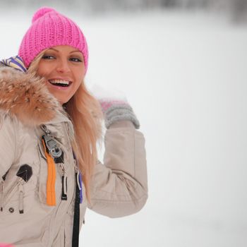 winter woman play snowballs on snow background