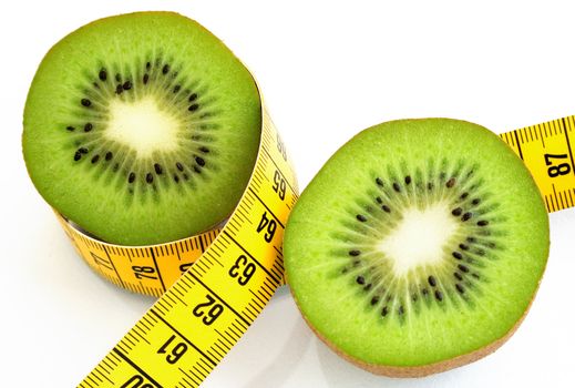 Kiwi slices and measuring tape. Isolated on a white background.