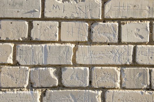 Wall made of white brick closeup detail background sunlighted by sun.