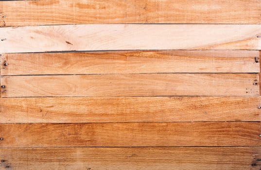 Textured bottom of the wooden box with hammered nails