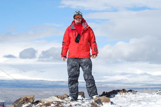 snowboarder high up in the mountains is sure of oneself 