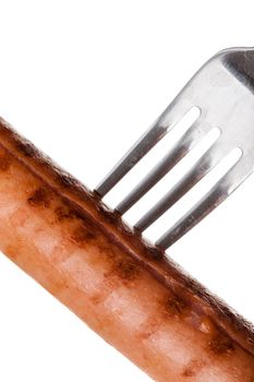 a delicious sausage on a fork over white