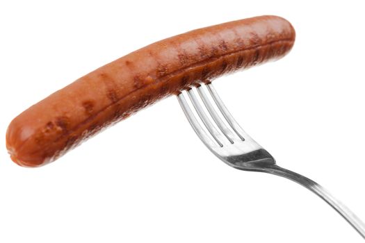 a delicious sausage on a fork over white