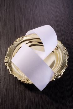 roll of paper on the golden plate