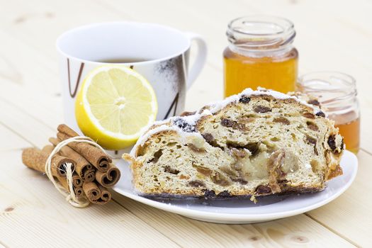 christmas stollen, honey, lemon and cinnamon sticks