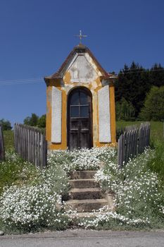 Village chapel in summer countryside against blue sky, Pohorje, Slovenia