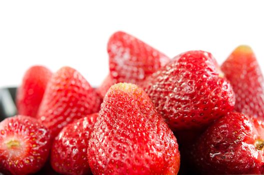 Fresh red strawberries  on  black plate