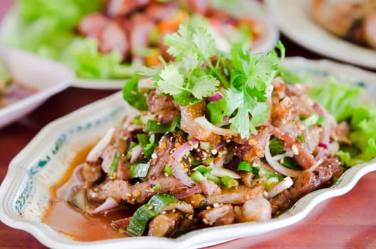 spicy slices pork on dish ,  mix vegetable  and chili sauce