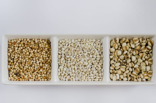 job's tears , barley and millet grains on white bowl