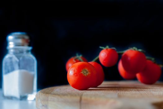 Little tomatoes on a wooden chopping board