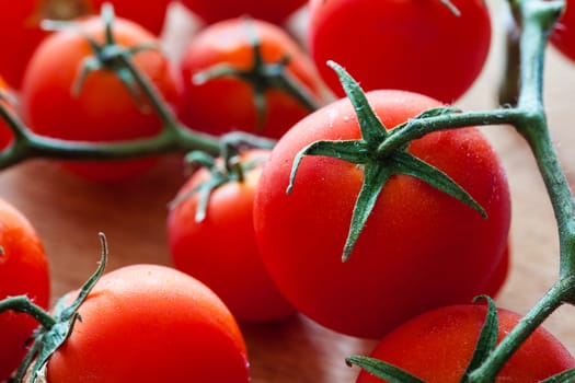 Little tomatoes on a wooden chopping board