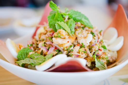 spicy shrimp on a salad with eggs and minced pork