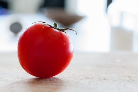 Little tomatoes on a wooden chopping board