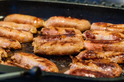 Cooking a succulent and spiced sausage on a grilling pan