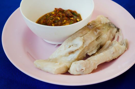 chili sauce and  fresh steam fish on pink dish