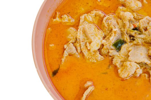 top view pork in ground peanut-coconut cream curry  in pink bowl on white