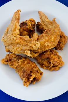  fried  chicken  on dish , blue background , fast food