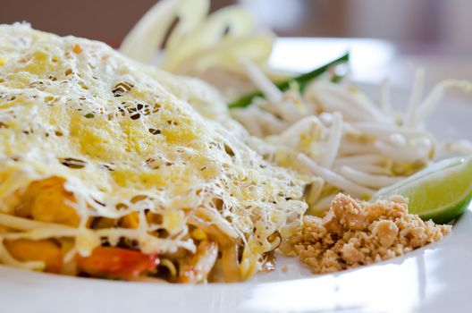Stir fry noodles and fried egg on top , asian food