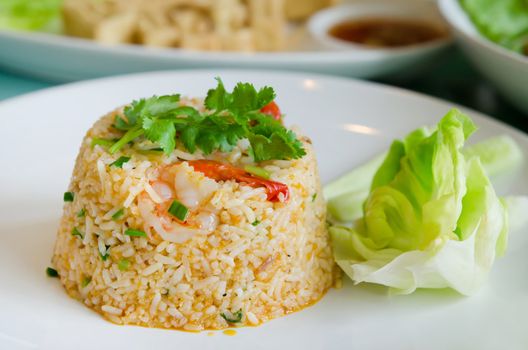 fried rice with  shrimp and vegetable on white plate