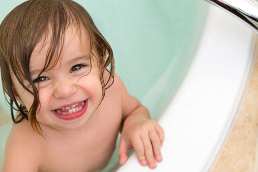 Cute Toddler Giving Toothy Smile from the Bath Tub