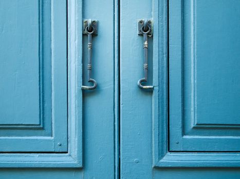 Pair of window hook on Blue wood window