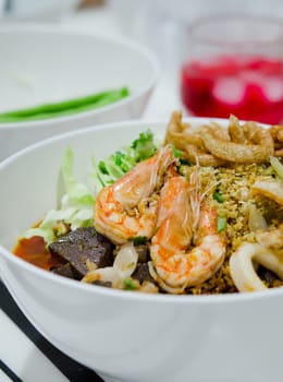rice noodles with spicy pork ,seafood sauce and vegetable