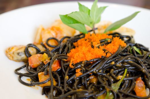 Black spaghetti with seafood  on white dish