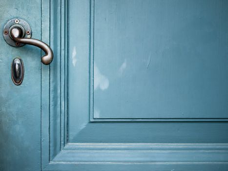 Single Door handle on old door painted with blue