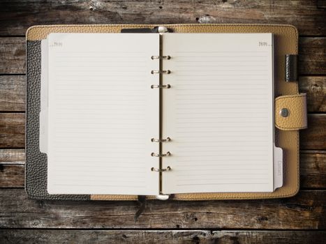Black and cream leather cover of binder notebook on wood