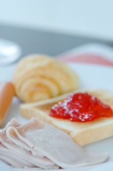 american style breakfast , with bacon, toast , jam and bread