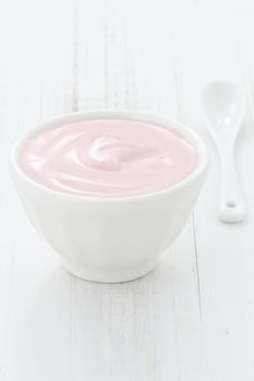 Fresh, healthy and delicious creamy, strawberry yogurt in vintage French cup, the perfect snack or dessert.