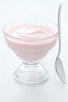 Fresh, healthy and delicious creamy, strawberry yogurt in vintage French cup, the perfect snack or dessert.