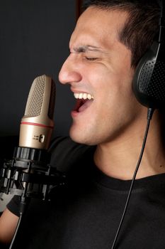 Rock artist recording his song in a studio 