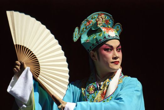 Chinese opera actor perform traditional drama on stage.