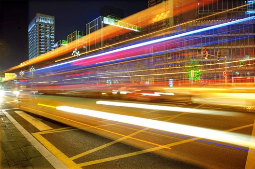 High speed and blurred bus light trails in downtown nightscape