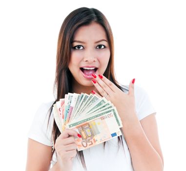 Portrait of an excited young woman holding money, isolated on white.