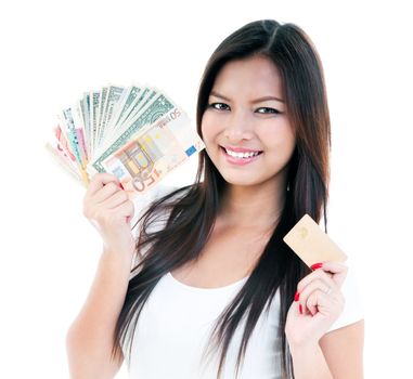 Portrait of a happy young woman holding money and credit card, isolated on white.