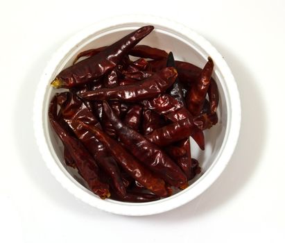 Dry red chili pepper in a  bowl isolated on white background