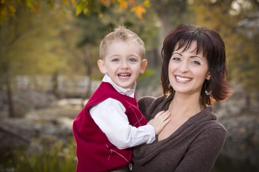 Attractive Mother and Cute Son Portrait Outside at the Park.