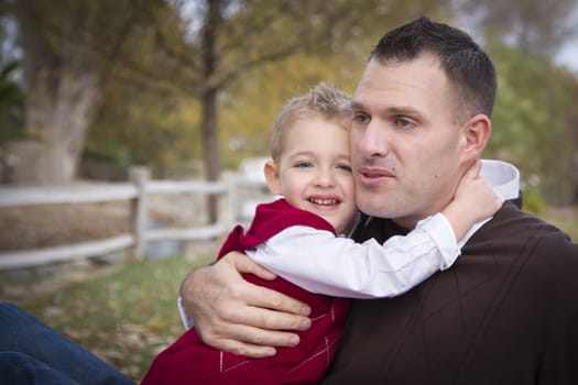 Handsome Father and Son Having Fun in the Park.