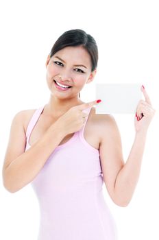 Young charming woman pointing at blank card over white background.