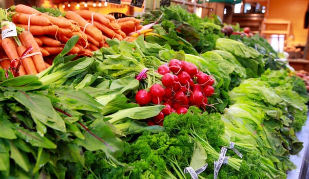 fresh vegetables radish, carrots, and greens  at the market