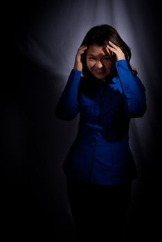 Asian girl in spotlight on black background