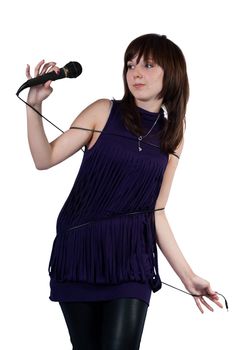 Cute girl wrapped in cord microphone on a white background