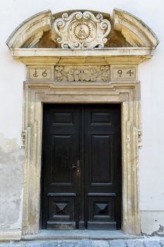 An old entrance to a public catholic school in lower austria