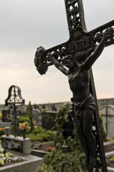 An almost falling Jesus in a rural cemetary in lower austria