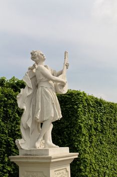 A female statue playing lute in the park of castle Belvedere, Austria