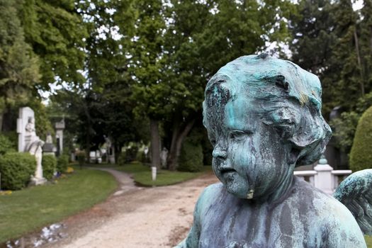 A baby angel at the entrance to Vienna's central cemetery